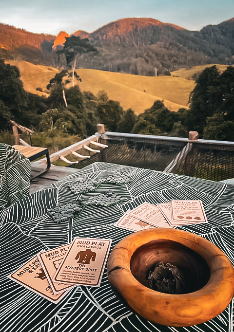 Mud play cards and a clay bowl set out on the deck at The Barrel Spa