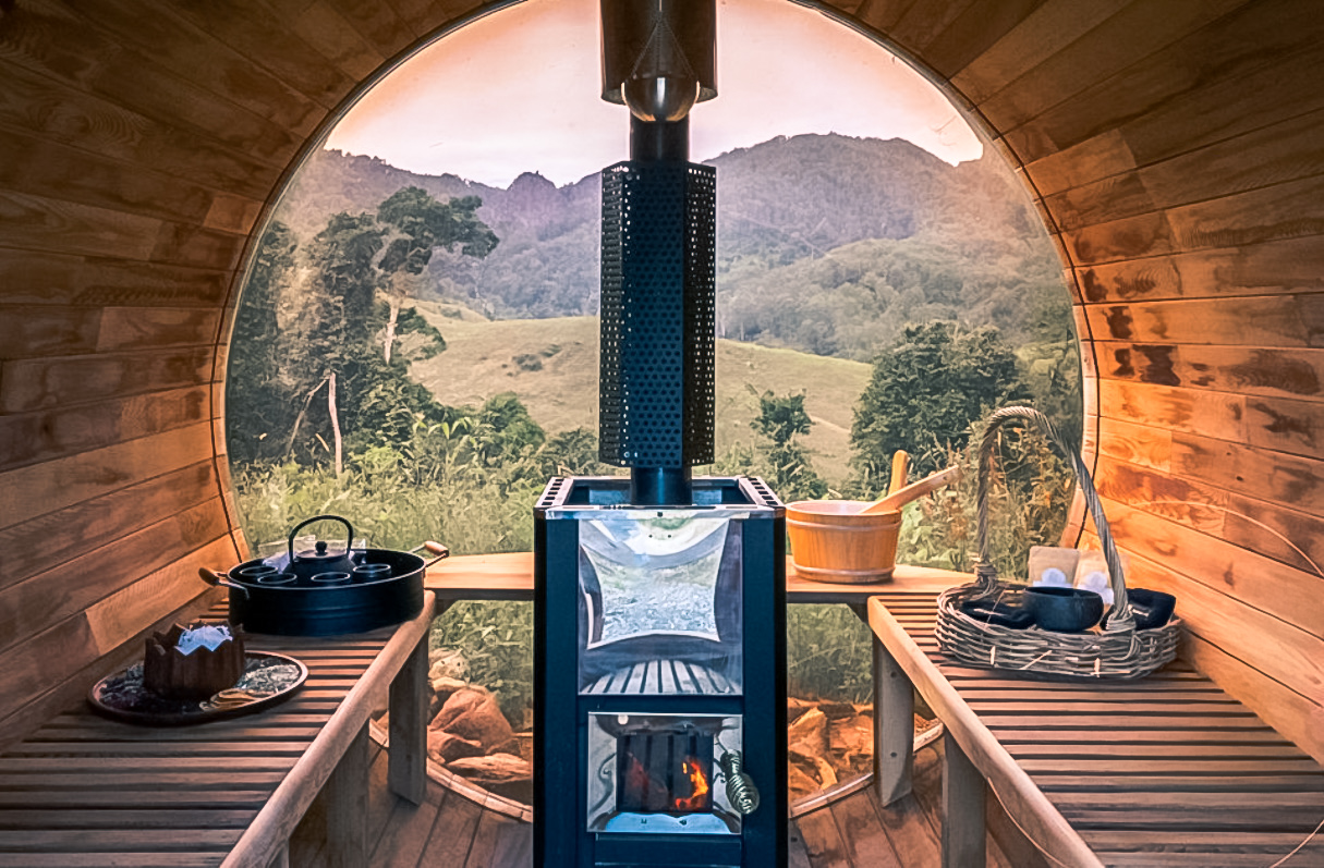 Inside the wood-fired barrel sauna, with mountain views through the window